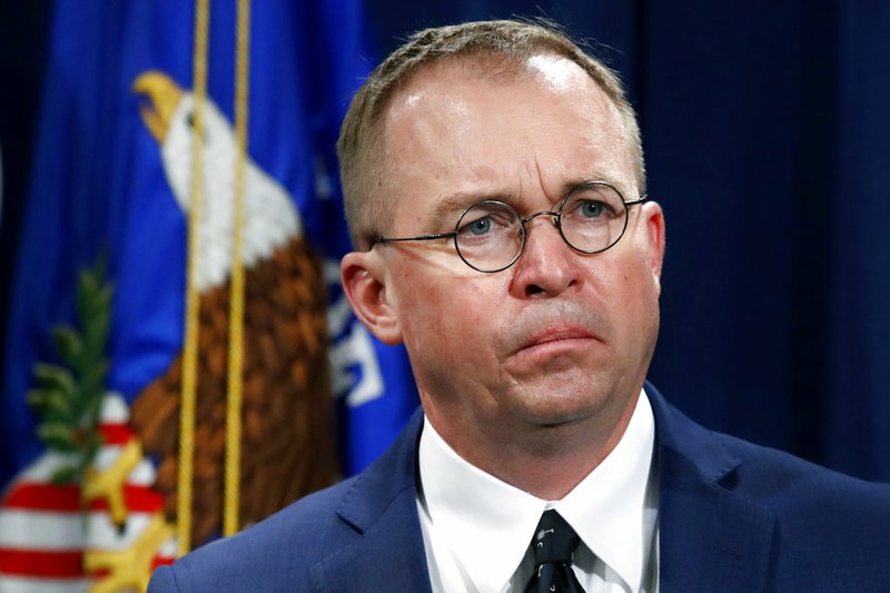 FILE- In this July 11, 2018, file photo Mick Mulvaney, acting director of the Consumer Financial Protection Bureau (CFPB), and Director of the Office of Management, listens during a news conference at the Department of Justice in Washington. Seth Frotman, the nation's top government official overseeing the $1.5 trillion student loan market resigned on Monday, citing what he says is the White House's open hostility toward protecting student loan borrowers. Frotman is the latest high-level departure from the CFPB since Mulvaney took over in late November. (AP Photo/Jacquelyn Martin, File)