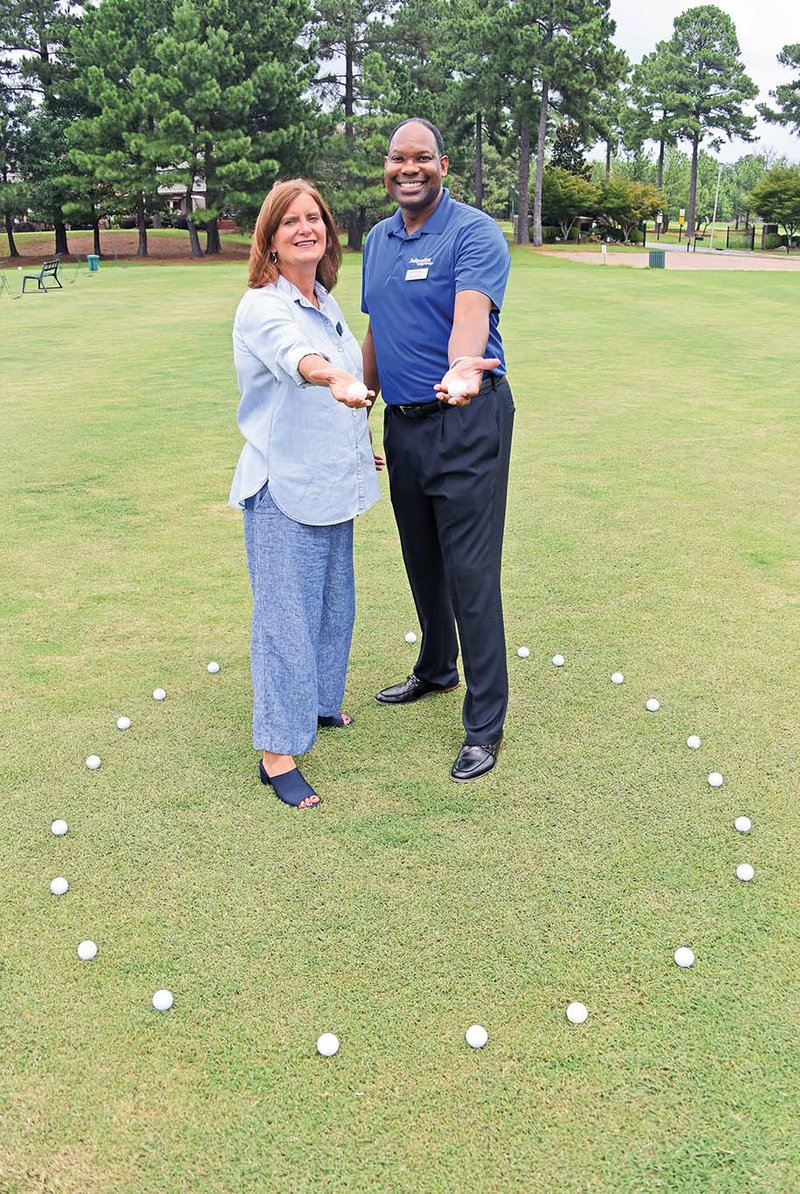 Elissa Douglas, executive director of Independent Living Services in Conway, and Robert Wright, director of development and supported employment for the nonprofit, stand on the Centennial Valley Country Club golf course. The 13th annual ILS Golf Ball Drop will be take place on the course from 5:30-7 p.m. Sept. 6. People can buy tickets for numbered golf balls, which will be dropped from a Conway Fire Department truck. The person whose ball is closest to an X on the ground will win $2,018.
