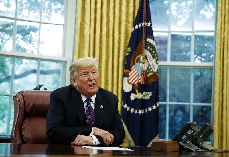 President Donald Trump, joined on the phone by Mexican President Enrique Pena Nieto, announces the trade agreement Monday in the Oval Office of the White House.
