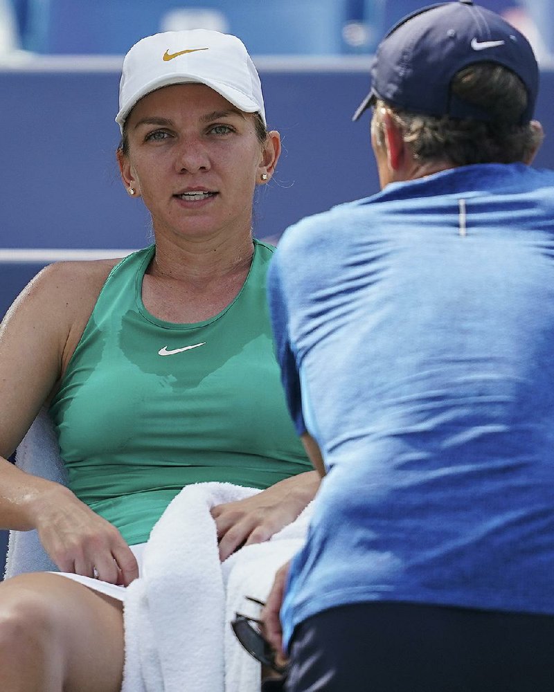 Simona Halep, of Romania, reacts during the finals against Kiki Bertens, of the Netherlands, at the Western & Southern Open tennis tournament, Sunday, Aug. 19, 2018, in Mason, Ohio. 