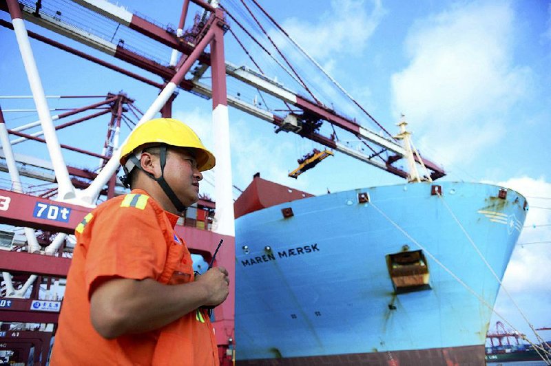 A worker stands near a container ship earlier this month at a port in Qingdao in eastern China. Beijing is responding to a trade war with the U.S. by pushing companies to curb reliance on U.S. goods, but finding alternative sources is proving difficult for them.