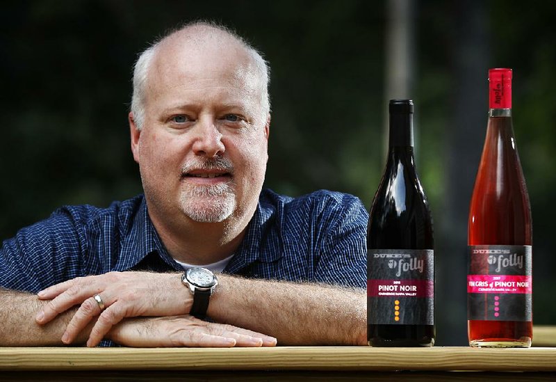 Kirk Duke, whose family runs a Napa Valley winery, poses with bottles of wine at his home in Falmouth, Maine. The business tried to trademark its wine Duke’s Folly, but tweaked it to Dukes’ Folly after Duke University intervened. 