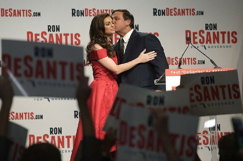 Ron DeSantis celebrates with his wife, Casey, at a watch party in Orlando after he won the Florida Republican gubernatorial primary, earning a congratulatory tweet from President Donald Trump. 