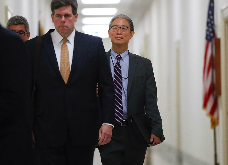 Bruce Ohr (rear, right), a Justice Department lawyer, arrives Tuesday for an interview with the House Judiciary and Oversight committees on Capitol Hill. 