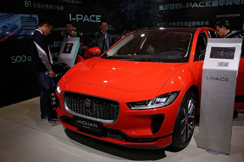 People look at a Jaguar electric-powered I-Pace SUV earlier this year at an auto show in Beijing. Jaguar Land Rover and other rivals of Tesla Inc. are moving aggressively into the luxury electric vehicle field. 