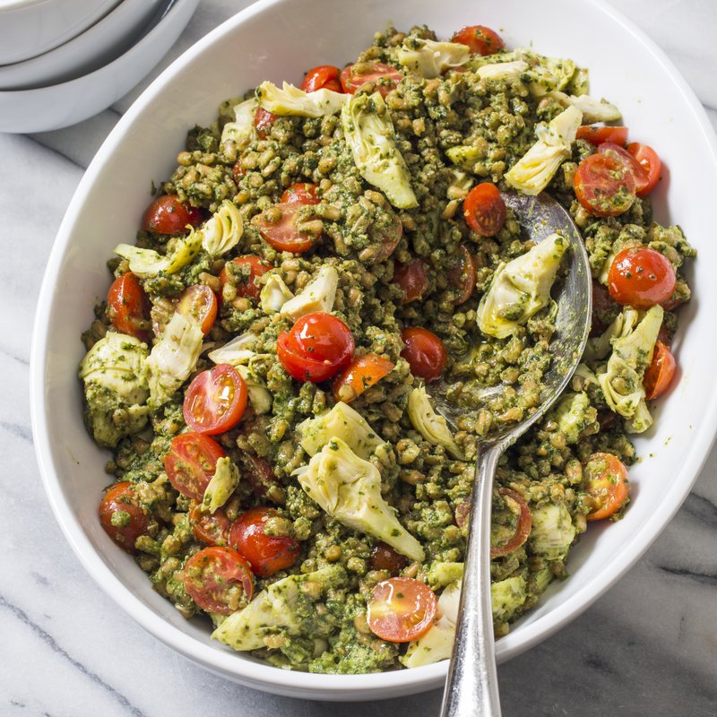 This undated photo provided by America's Test Kitchen in May 2018 shows pesto farro salad in Brookline, Mass. This recipe appears in the cookbook "Nutritious Delicious."