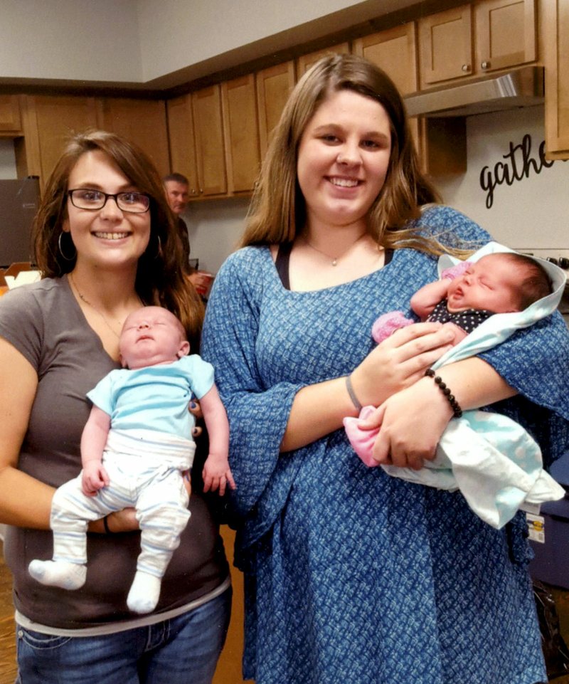 Photo by Snooky Garrett Lyndsy Garrett is holding three-week-old Zechariah, and Courtney Porter is holding 11-day-old Letti Nichole, the newest members of the Payne family. The two youngsters were introduced to many new family members at a family reunion lunch Sunday, Aug. 12, at the Hiwasse Community Building.