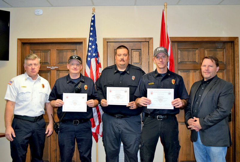 Photo by Mallory Weaver Gravette fire chief Lonnie Mullen (left) and Mayor Kurt Maddox (right) pose with Lieutenant Jared Weston, fireman/paramedic Brad Harris and Captain David Orr as they display their certificates for Fire Officer. These Gravette Fire Department personnel received their certification in an Arkansas Fire Academy course on July 27 and are participating in an ongoing department training program.