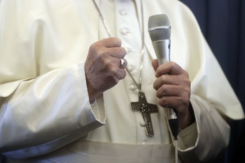 Pope Francis gestures as he answers to a journalist's question during a press conference aboard of the flight to Rome at the end of his two-day visit to Ireland, Sunday, Aug. 26, 2018.