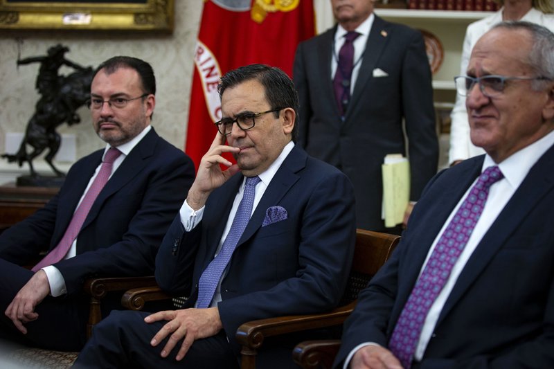 Luis Videgaray, Mexico's foreign minister, left, Ildefonso Guajardo Villarreal, Mexico's secretary of economy, center, and Jesus Seade, chief negotiator for Mexico's president-elect Andres Manuel Lopez Obrador, listen during a phone conversation between U.S. President Donald Trump and Enrique Pena Nieto, Mexico's president, not pictured, in the Oval Office of the White House, on Monday, Aug. 27. 