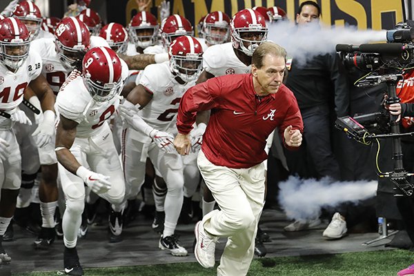 In this Jan. 8, 2018, file photo, Alabama head coach Nick Saban leads his team on the field before the NCAA college football playoff championship game against Georgia, in Atlanta. (AP Photo/David Goldman,)

