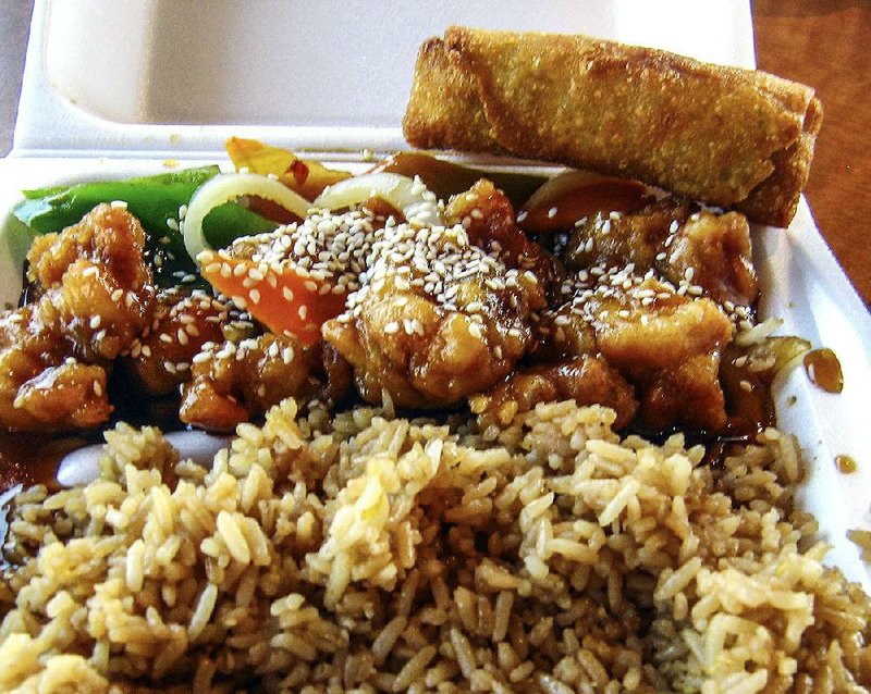 The crisp sesame chicken at Asia Express in Cabot, served with rice and an egg roll, comes coated in a brown sauce, mixed with vegetables and sprinkled with sesame seeds.  