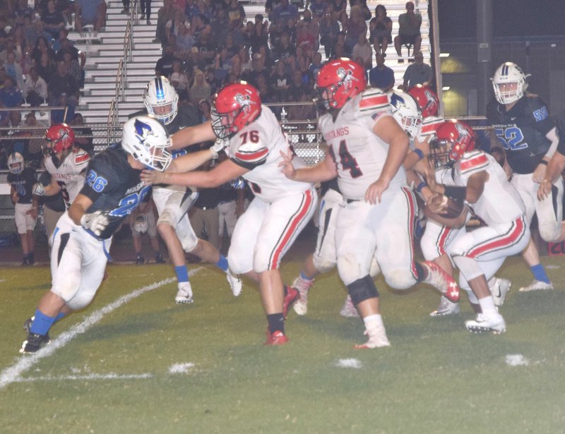 RICK PECK/SPECIAL TO MCDONALD COUNTY PRESS McDonald County offensive linemen Will Gordon (76) and Elliott Wolfe (74) lead quarterback Ben Mora around the end for a nice gain during the Mustangs 41-7 loss on Aug. 24 at Marshfield High School.
