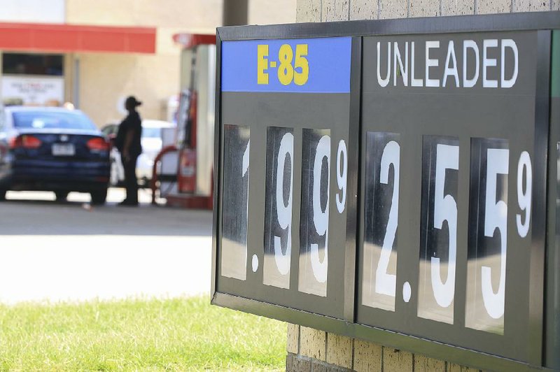 A motorist fuels up Thursday at the Kum and Go on Springhill Drive in North Little Rock. At $2.56, the average price for regular gasoline is 30 cents higher than it was during last year’s Labor Day weekend.