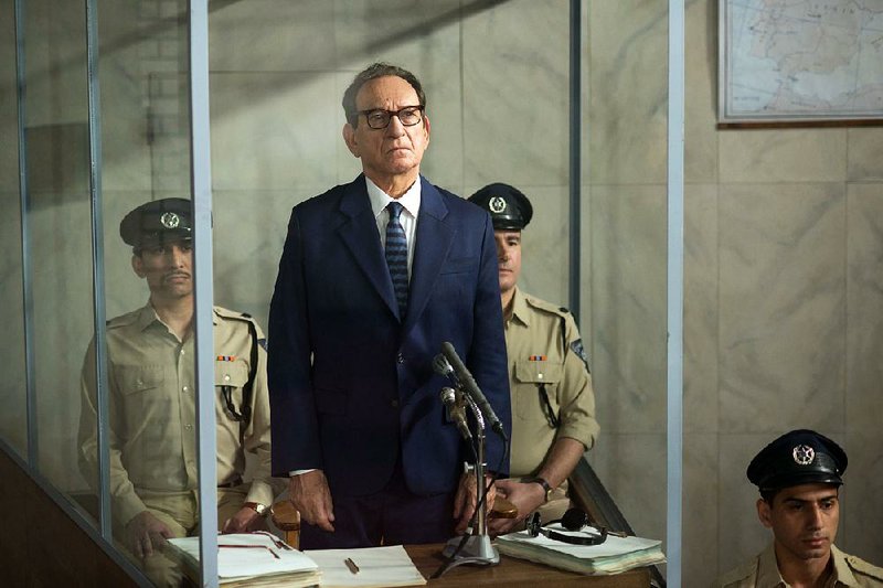 Adolf Eichmann (Ben Kingsley), the German Nazi SS-Obersturmbannfuhrer who managed the logistics of the Holocaust, stands in a bullet-proof glass booth during his war crimes trial in Chris Weitz’ Operation Finale.