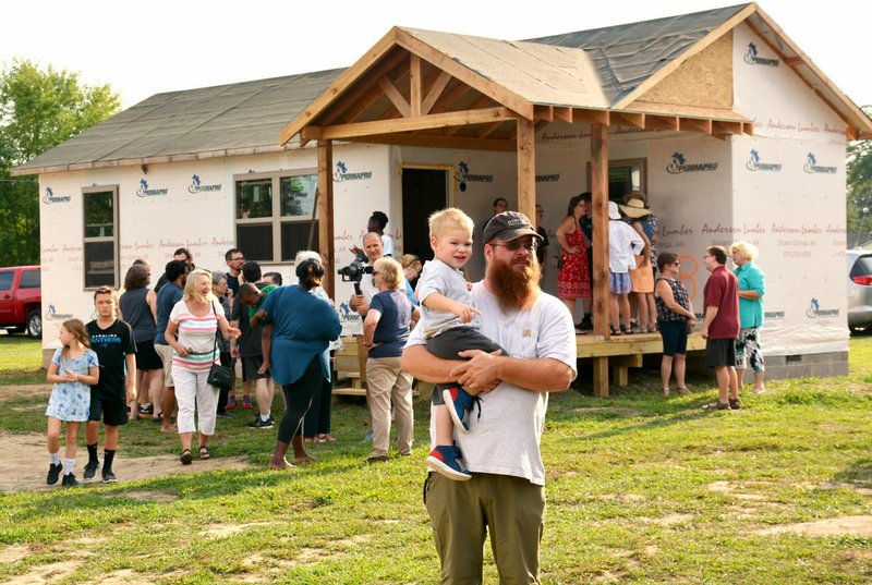 NWA Democrat-Gazette/JANELLE JESSON Two of the four tiny houses in the Genesis House were open for tours during the reveal in Siloam Springs. The houses are between 400 to 600 square feet and will house families of up to six. They are about 70 percent complete.