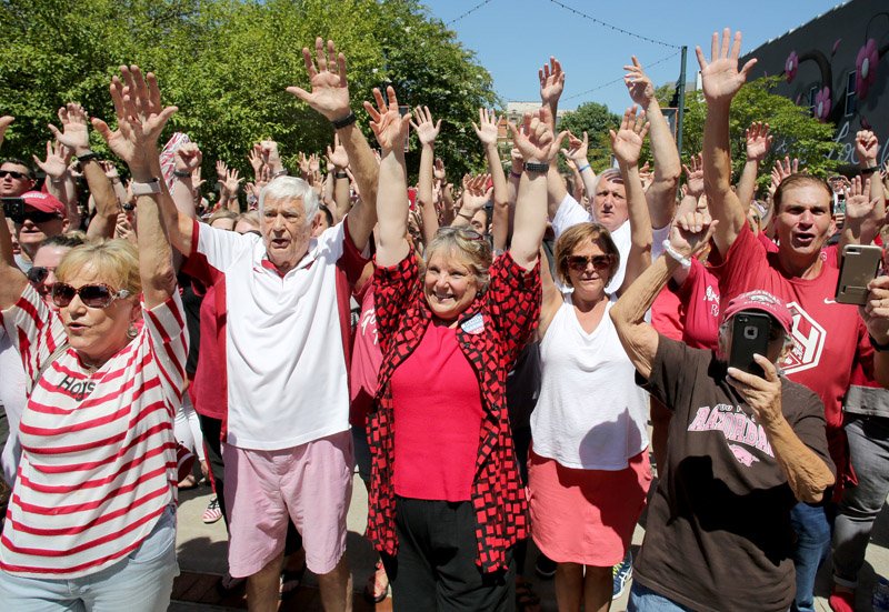 NWA Democrat-Gazette/DAVID GOTTSCHALK University of Arkansas Razorback fans participate in the Hog Call Friday during the ONE Hog Call event at the Town Center in downtown Fayetteville. The ONE Hog Call took place at 1:00 p.m. central standard time and asked fans in specific and spontaneous locations to participate in the cheer in an effort to unite Razorback fans across the globe. For more photographs and to hear the ONE Hog Call go to NWADG.com/photo and NWADG.com/video.
