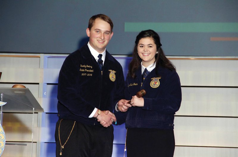 New Arkansas FFA state president Dawsyn Smith of Newport, right, receives a gavel from outgoing president Brady Gentry of Spring Hill during the 2018 FFA state convention at the Hot Springs Convention Center in April. Smith is a freshman at Southern Arkansas University in Magnolia.