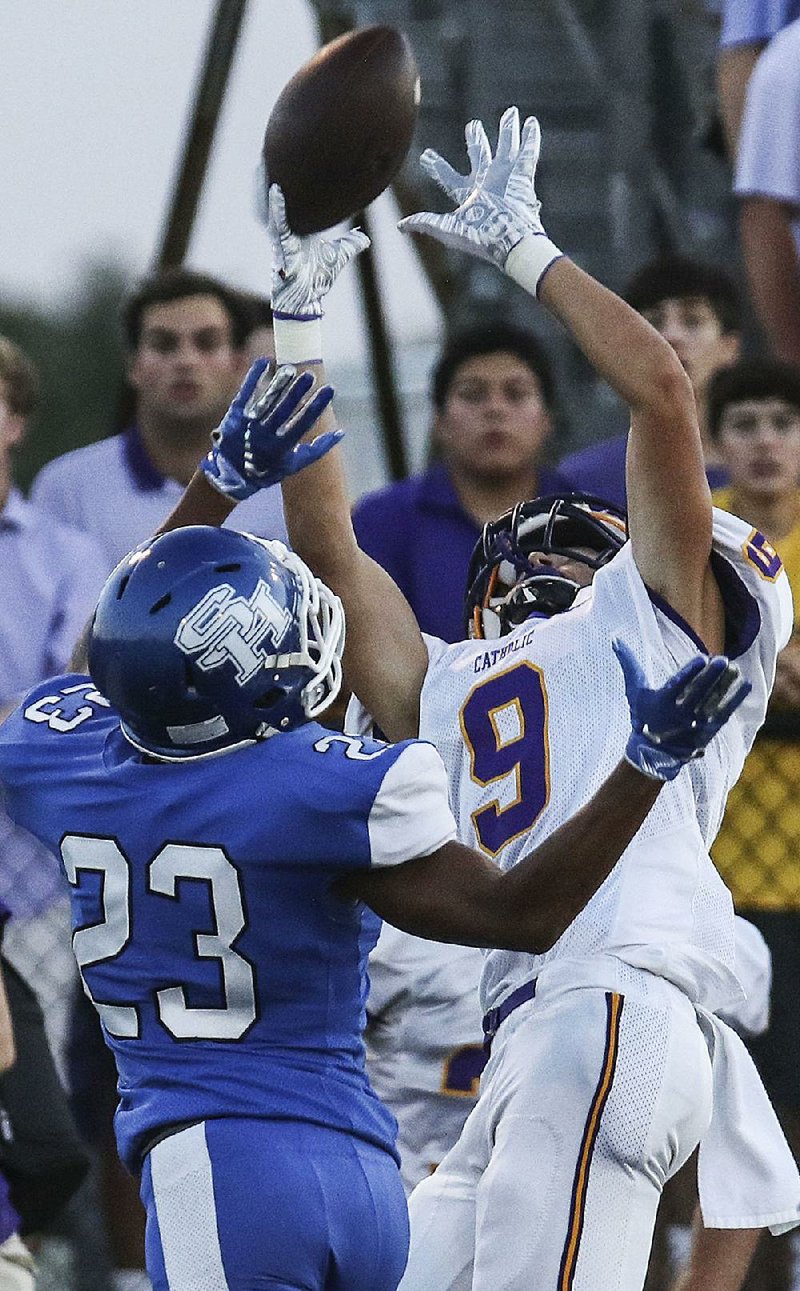 Little Rock Catholic wide receiver Nathan Johnson (9) makes a catch against Sylvan Hills defensive back Khalil Muhammad during the Rockets’ 20-2 victory over the Bears on Friday. For more high school football photos, visit arkansasonline.com/galleries.