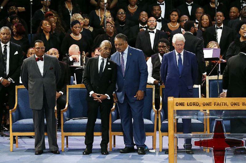 The Rev. Louis Farrakhan, (from left) the Rev. Al Sharpton, the Rev. Jesse Jackson and former President Bill Clinton attend the funeral service Friday for Aretha Franklin at Greater Grace Temple in Detroit.