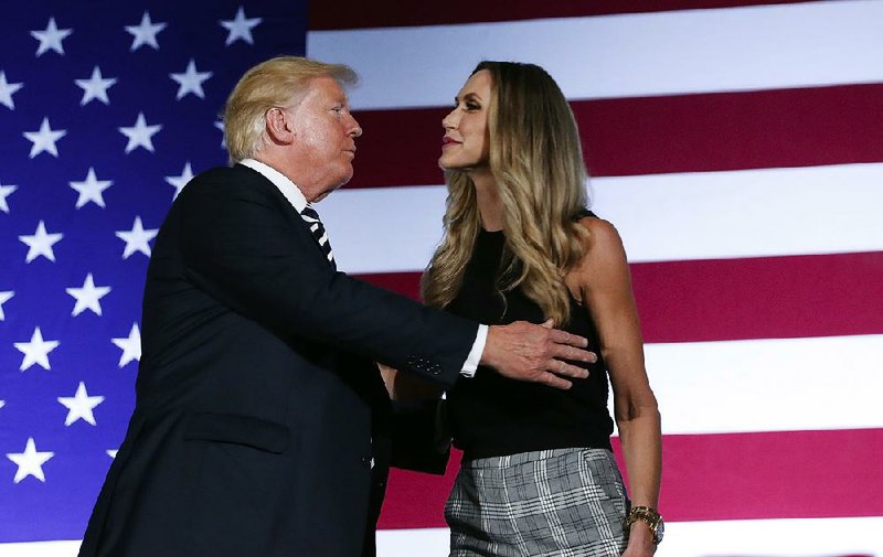 President Donald Trump embraces his daughter-in-law, Lara Trump, after she introduced him Friday at a Republican fundraiser in Charlotte, N.C. 