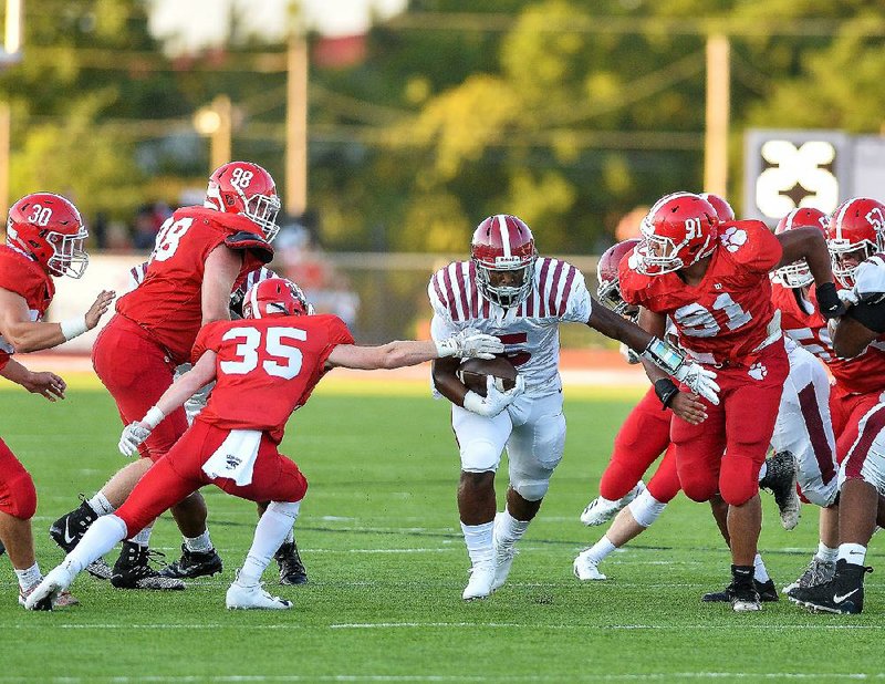 Pine Bluff running back Kemariea Wilkins (center) breaks away from Cabot defenders Justin Holland (35) and Hensolyne Dixon (91) during Friday night's game at Panther stadium in Cabot.

Special to the Democrat-Gazette/JIMMY JONES