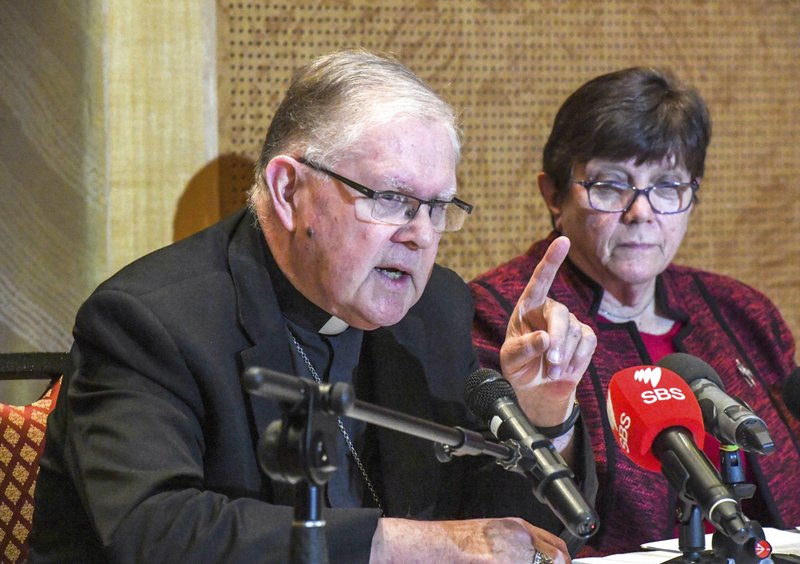 Australian Catholic Bishops Conference President Archbishop Mark Coleridge speaks to the media alongside Catholic Religious Australia President Sister Monica Cavanagh, right, during a press conference in response to the child abuse royal commission's recommendations in Sydney, Friday, Aug. 31, 2018. The Catholic Church in Australia on Friday rejected a recommendation by a government inquiry that priests be required to report evidence of child sex abuse disclosed in the confessional. The recommendation that priests be prosecuted for failing to report evidence of pedophilia heard in the confessional was a key finding in December of Australia's Royal Commission into Institutional Responses to Child Sexual Abuse. (Peter Rae/AAP Image via AP)