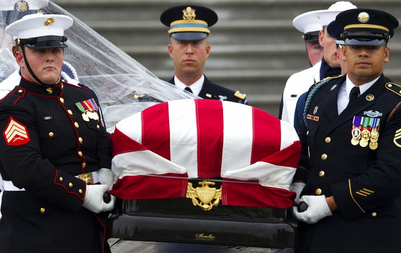 The flag-draped casket of Sen. John McCain, R-Ariz., is carried to a hearse from the U.S. Capitol in Washington, Saturday, Sept. 1, 2018, in Washington, for a departure to the Washington National Cathedral for a memorial service. McCain died Aug. 25 from brain cancer at age 81. story.lead_photo.caption