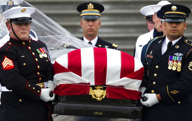 The flag-draped casket of Sen. John McCain, R-Ariz., is carried to a hearse from the U.S. Capitol in Washington, Saturday, Sept. 1, 2018, in Washington, for a departure to the Washington National Cathedral for a memorial service. McCain died Aug. 25 from brain cancer at age 81.