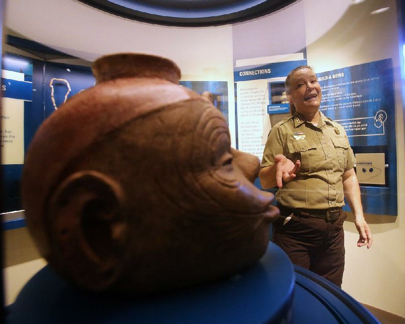 Arkansas State Park Interpreter Sherry Hawkins talks about the effigy headpots to go on display at the Hampson Archeological Museum State Park in Wilson