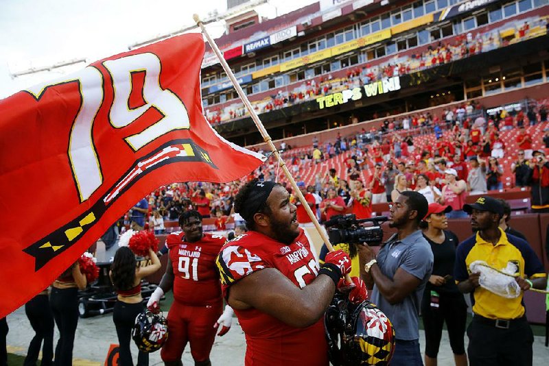 Maryland offensive lineman Ellis McKennie waves a flag in remembrance of Jordan McNair, who died after collapsing during a spring workout. The Terrapins also lined up with 10 men on the field for the first play of their 34-29 victory over Texas on Saturday. The Terrapins were penalized for delay of game, but the Longhorns declined the penalty.