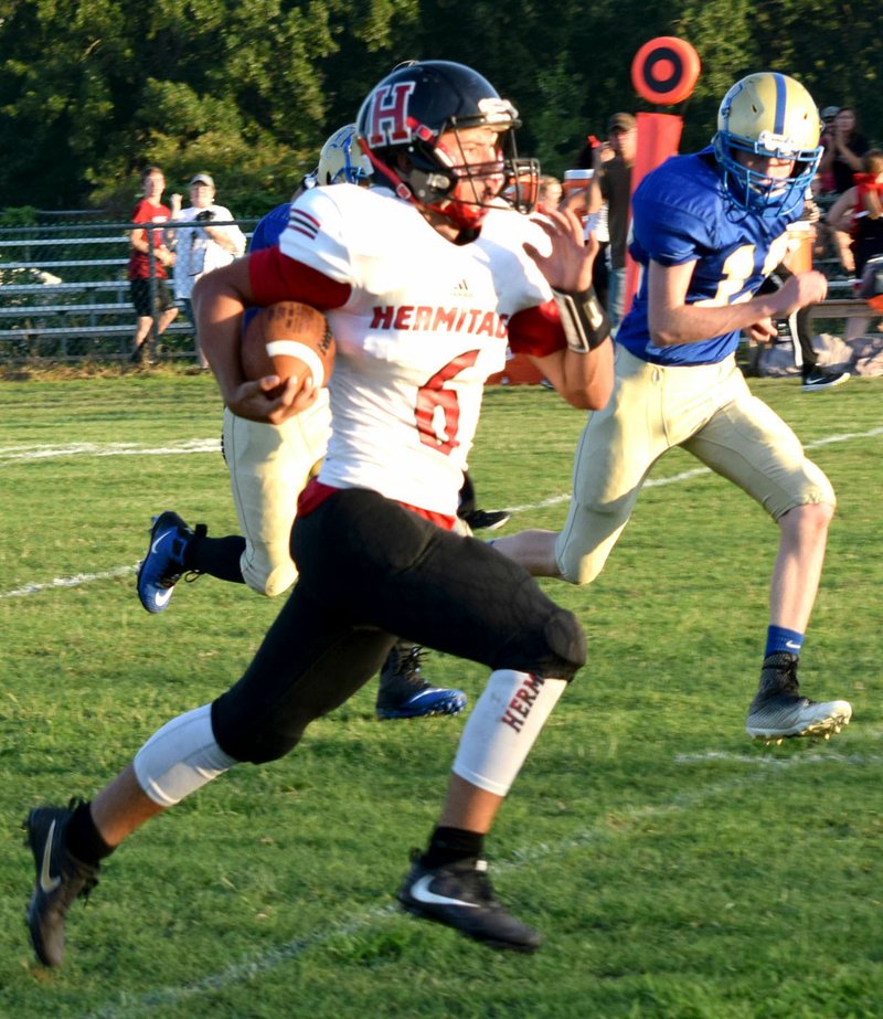 Westside Eagle Observer/MIKE ECKELS Hermits quarterback Dillon Quimby (6) out runs several Bulldogs defenders for a 45 yard touchdown during the Aug. 31 Decatur-Hermitage eight-man football contest at Bulldog Stadium in Decatur. Hermitage claimed victory in the contest 38-32 over Decatur.