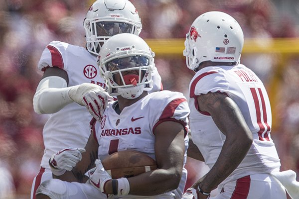 Arkansas cornerback Chevin Calloway (1) celebrates with Ryan Pulley (11) during a game against Eastern Illinois on Saturday, Sept. 1, 2018, in Fayetteville. 