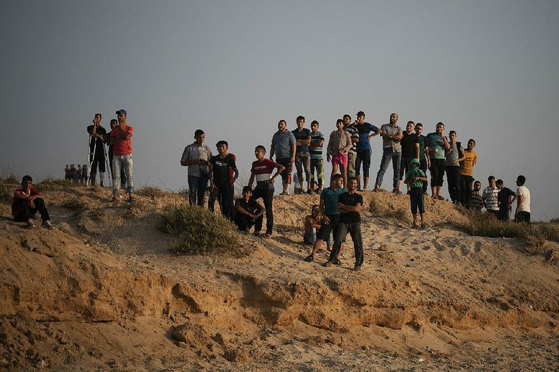 Palestinian protesters gather Sunday on the beach in the Gaza Strip city of Beit Lahiya, near the border with Israel. 