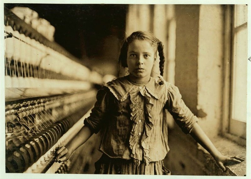 A young spinner in a North Carolina cotton manufacturing company poses for Lewis Hine, the documentary photographer who inspired the creation of laws to ban child labor. MUST CREDIT: Library of Congress