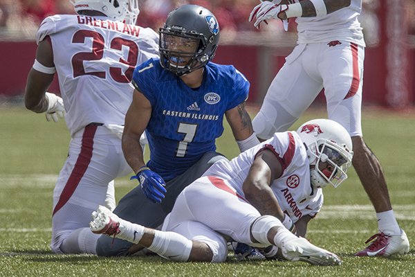 Dre Greenlaw (23), Arkansas linebacker, and Chevin Calloway, Arkansas cornerback, tackle Aaron Gooch, Eastern Illinois wide receiver Saturday, Sept. 1, 2018, in the first quarter at Razorback Stadium in Fayetteville. The tackle forced a fumble recovered by Calloway.