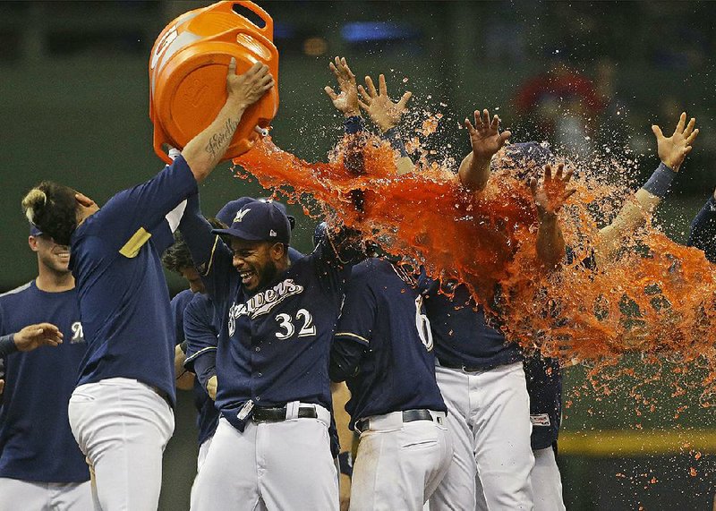 Hernan Perez of the Milwaukee Brewers douses teammates with Gatorade after they walked off on the Chicago Cubs 4-3 on Monday in Milwaukee.