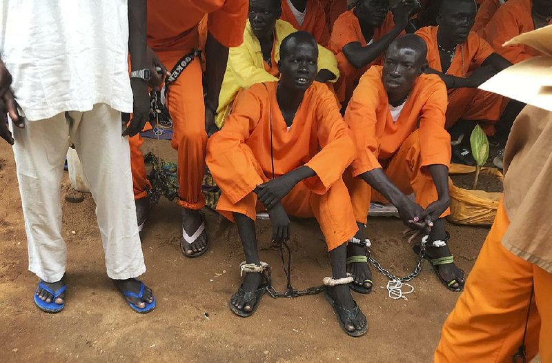 Prisoners sit bound together at the central prison in Juba, South Sudan, in this undated photo. 
