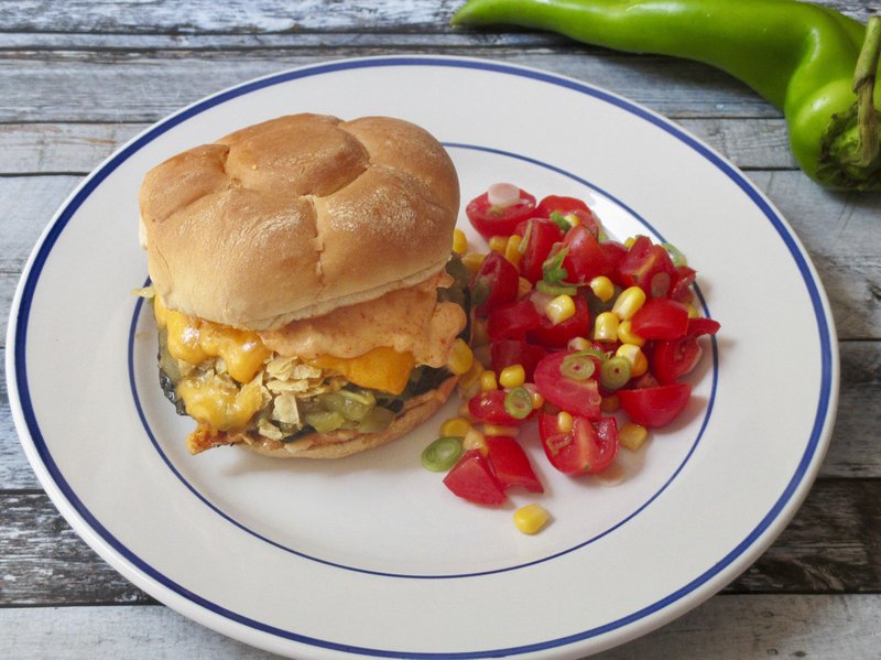 This Aug. 9, 2018 photo shows a green chile cheese portobello burger in New York. This dish is from a recipe by Sara Moulton. (Sara Moulton via AP)