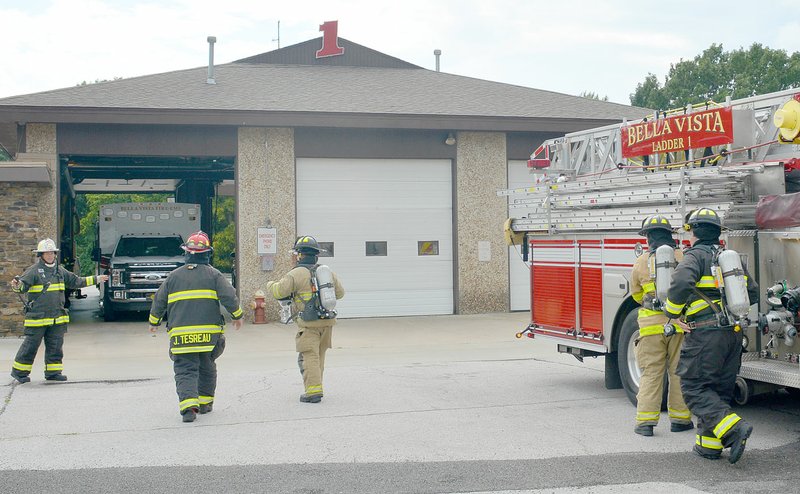 Keith Bryant/The Weekly Vista Firefighters prepare to handle a simulated fire scenario at Fire Station 1. Scott Cranford, the division chief responsible for training, said the department is very limited in training because using commercial properties can be disruptive and damage the pavement, acquiring a structure to burn can prove dangerous and firefighters can't perform all their skills at the fire station without risking damage to the building. The proposed training facility will fix that, he said.