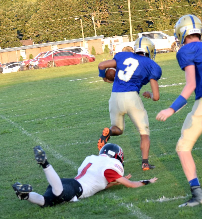 Westside Eagle Observer/MIKE ECKELS Jimmy Mendoza (Decatur 3) slips a Hermitage tackle and finds an open field for a 65-yard touchdown run late in the first quarter of the Decatur-Hermitage football contest at Bulldog Stadium in Decatur Aug. 31. Hermitage won the first Arkansas eight-man football league game, 38-32, over Decatur.