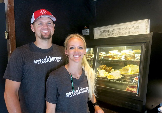 Westside Eagle Observer/SUSAN HOLLAND Dierek and Dani Madison pose beside the dessert case at the Station Cafe in Gravette. The Madisons opened the restaurant Aug. 24 and invite all in the area to come in, dine with them and sample a sweet treat from the tempting array of pies and brownies. Open hours for the business are 7 a.m. to 9 p.m. Monday through Saturday.