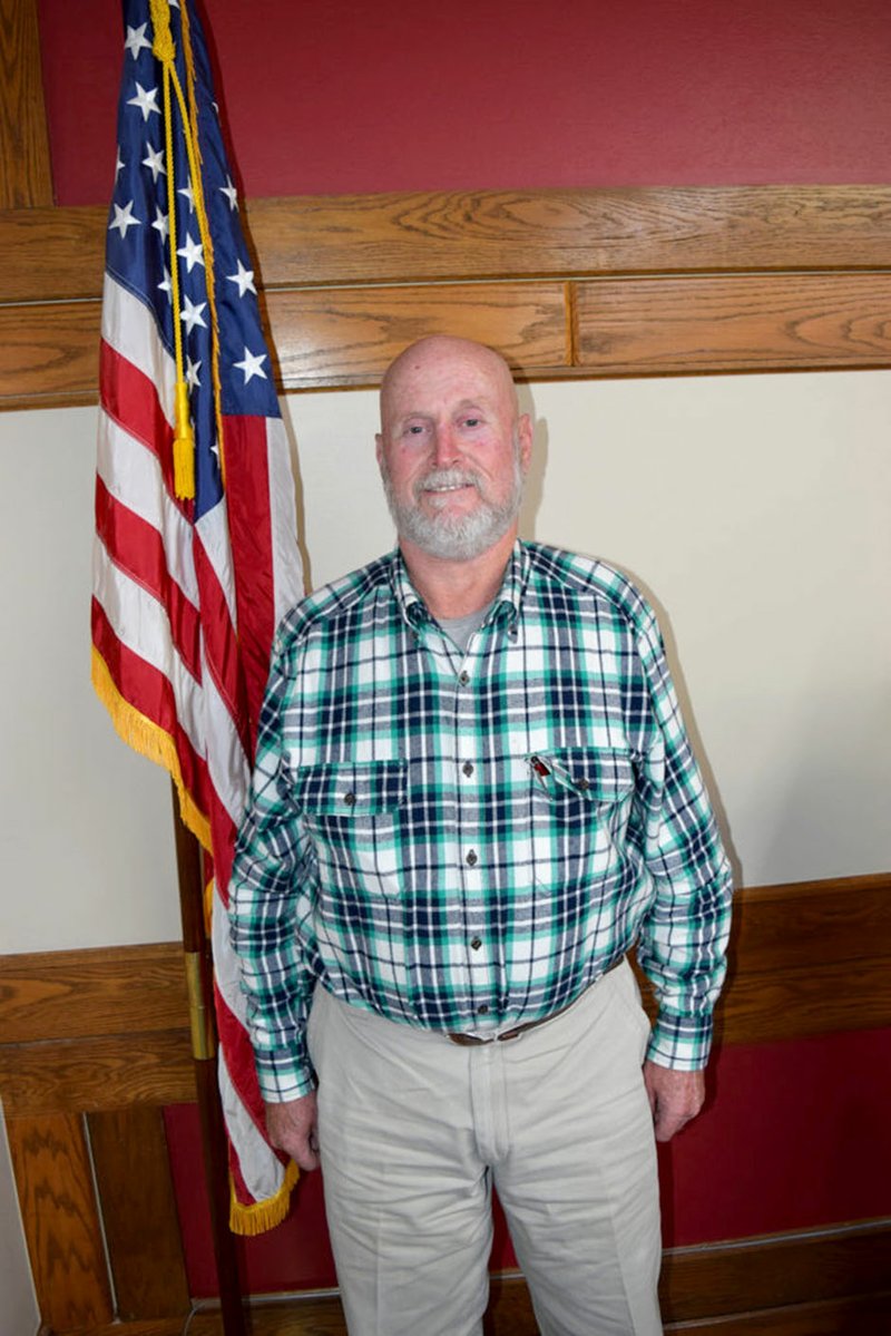 Westside Eagle Observer/MIKE ECKELS Former Decatur Mayor Bill Montgomery stands in front of the American flag after taking the oath of office as a Decatur alderman on Jan. 9, 2017. Montgomery passed away at his home in Decatur Aug. 30.