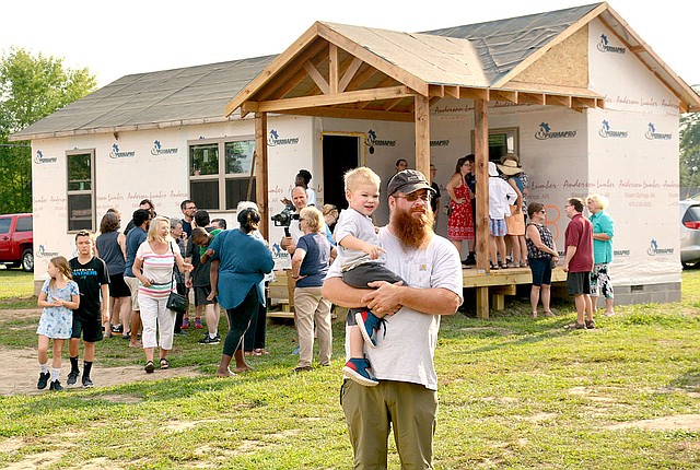 NWA Democrat-Gazette/JANELLE JESSON Two of the four tiny houses in the Genesis House were open for tours during the reveal in Siloam Springs. The houses are between 400 to 600 square feet and will house families of up to six. They are about 70 percent complete.