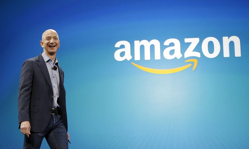 FILE - In this June 16, 2014, file photo, Amazon CEO Jeff Bezos walks onstage for the launch of the new Amazon Fire Phone, in Seattle. (AP Photo/Ted S. Warren, File)