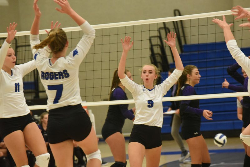 NWA Democrat-Gazette/FLIP PUTTHOFF Gracie Carr (11), Anna Randels (7) and Tatum McClure (9) celebrate a point for Rogers.