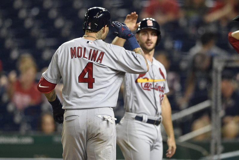 St. Louis Cardinals' Yadier Molina (4) celebrates his grand slam with Paul DeJong, back, during the ninth inning of a baseball game against the Washington Nationals, Tuesday, Sept. 4, 2018, in Washington. The Cardinals won 11-8. (AP Photo/Nick Wass)