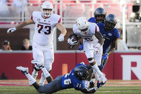 Arkansas Razorbacks running back T.J. Hammonds (6) runs the ball as Eastern Illinois Panthers defensive back Jordan Jackson (26) tackles during a football game, Saturday, September 1, 2018 at Razorback Stadium in Fayetteville.