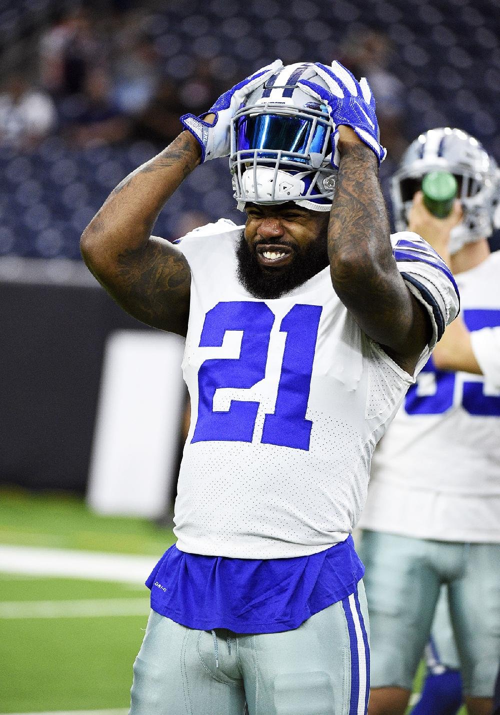 In this Aug. 9, 2018, file photo, Dallas Cowboys running back Ezekiel  Elliott (21) smiles as he runs off the field after the first half of an NFL  preseason football game against