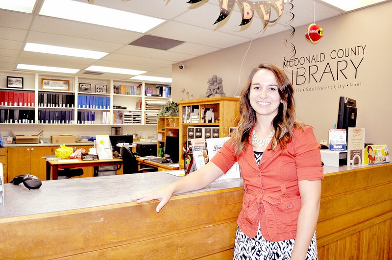 RACHEL DICKERSON/MCDONALD COUNTY PRESS McDonald County Library Director Amy Wallain stands next to the circulation desk at the Pineville branch, which will soon be replaced, thanks to a grant.